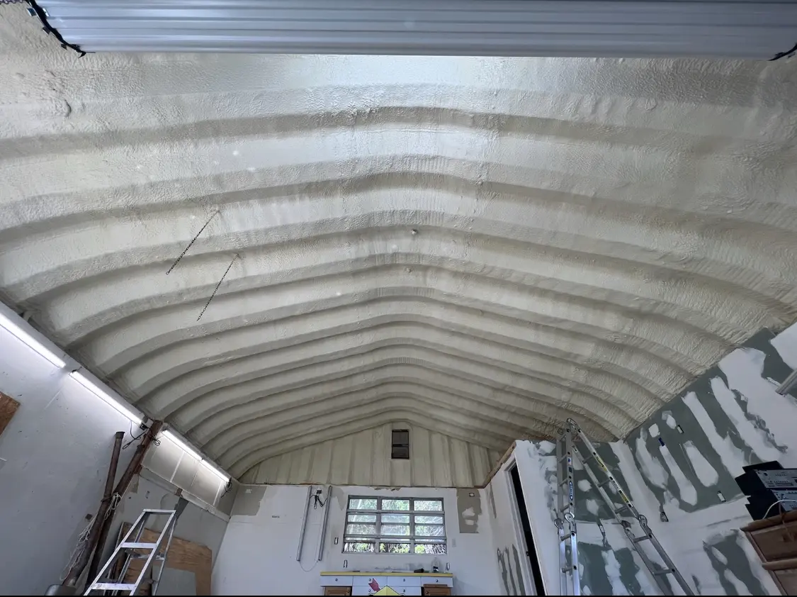 Spray polyurethane foam applied to the underside of a metal roof deck in Tracy